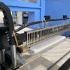 Automatic shrink wrapping machines with continuous side sealer